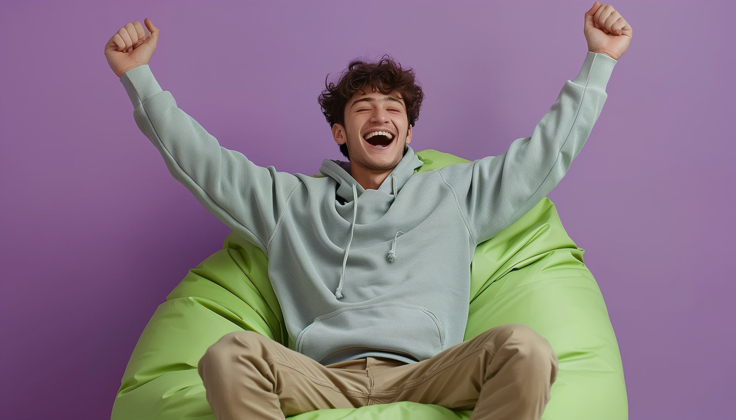 Exuberant Young Man on Green Beanbag Chair.jpeg